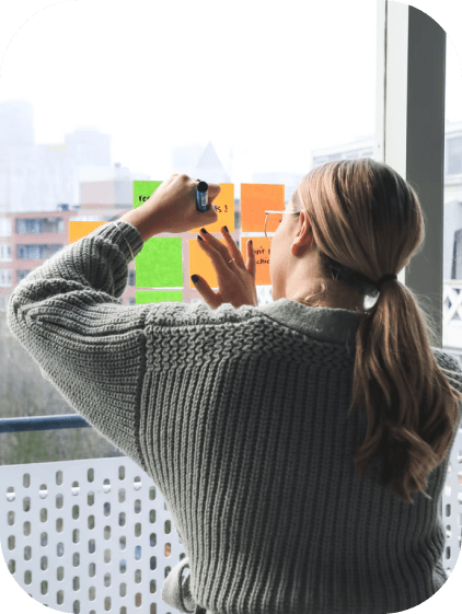woman sticking notes on a window